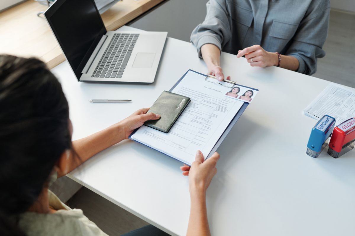 Employee reviewing visa transfer documents with an employer in the U.S.